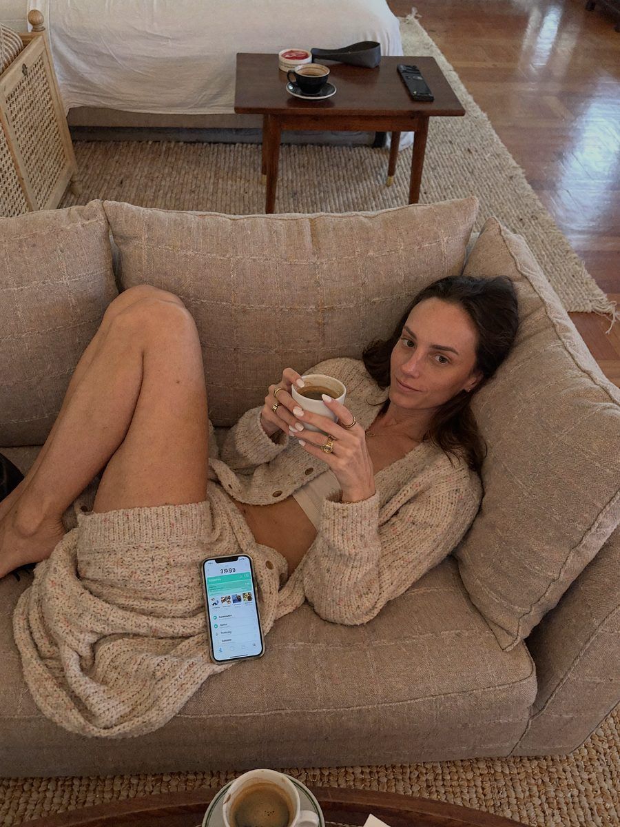 A woman relaxing on a cream sofa